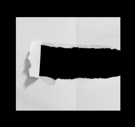 Hole ripped in white paperの写真素材