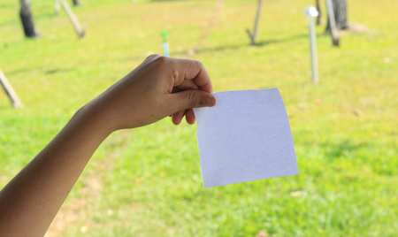 Empty paper sheet in a handの写真素材