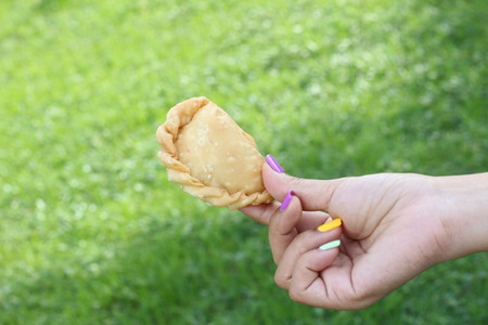 curry puff in hand
