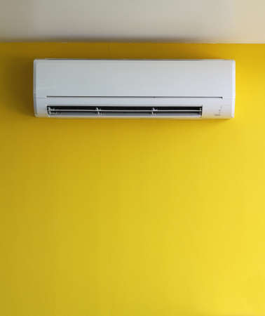 air conditioner on yellow wall