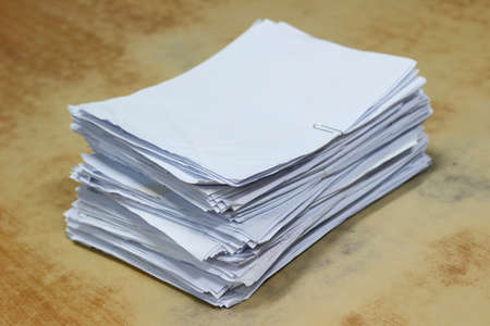 stack pile of paper on wood table backgroundの写真素材