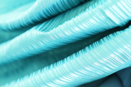 macro texture of light blue satin fabric as background, studio shotの写真素材