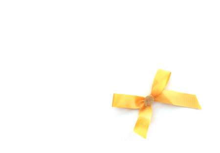 Yellow ribbon bow isolated on white background with copy space for text.の写真素材