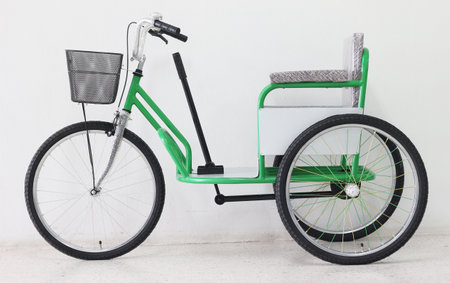 Green tricycle on a white background. The concept of ecological transport.の写真素材
