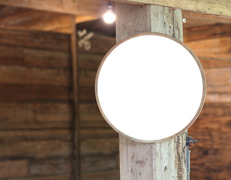 Blank white round signboard on wooden wall background. Mock upの写真素材