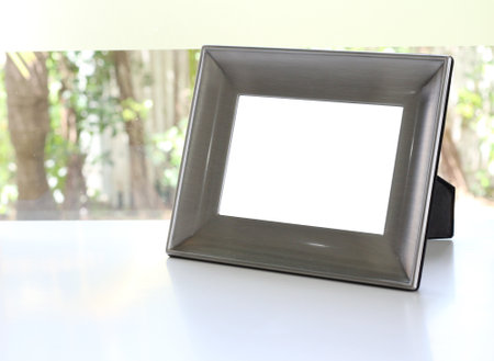 Empty picture frame on white table in the living room, stock photo