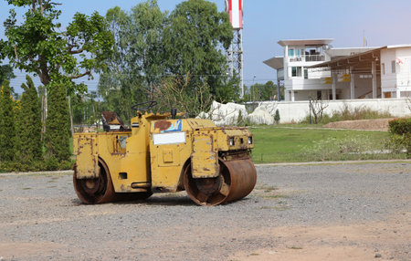The road roller on the background of the construction site. Road roller