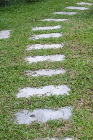 Stone walkway in the garden with green grass background, stock photoの写真素材