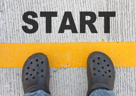 Man standing on the yellow line with start word. Business concept.の写真素材
