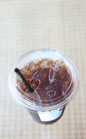 Iced coffee in plastic cup on the table. Top view.の写真素材