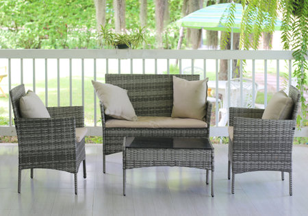 Outdoor patio with wicker rattan chairs and table, stock photo