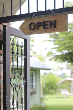 Open sign on the gate of a house in the garden, stock photoの写真素材