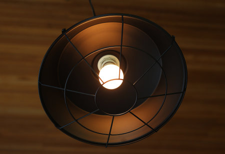 Ceiling lamp on a wooden wall, closeup of photoの写真素材