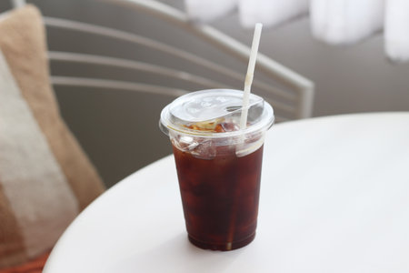 Iced cola in plastic cup on the table, stock photo