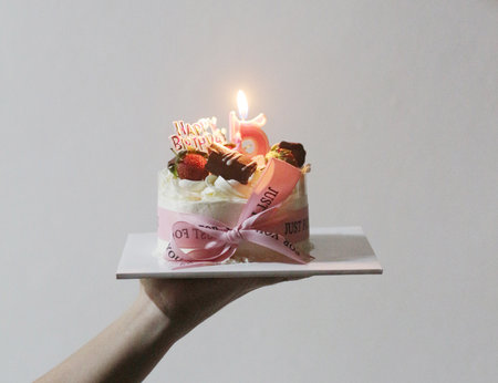 Birthday cake with candles on white background. Shallow dof.