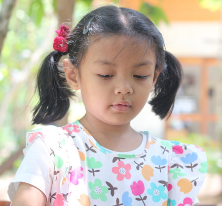 Portrait of a little Asian girl in the garden, Thailand.