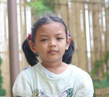 Portrait of a little asian girl in the garden, Thailand.