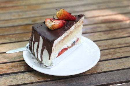 Strawberry cake on wooden table. Selective focus and shallow depth of field.