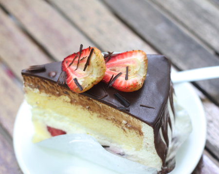 Chocolate cake with strawberry on wooden table, selective focus and vintage toneの写真素材