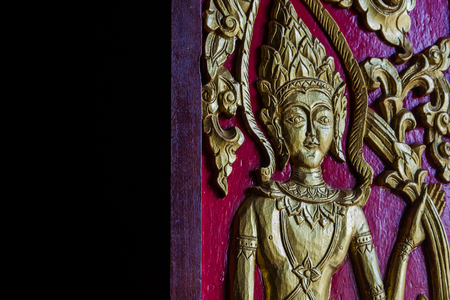 The carved door panels are beautifully decorated with gilded black lacquer, Chiang Mai, Thailandの写真素材