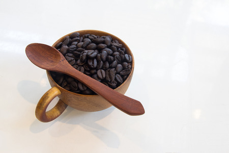 Cup with coffee beans isolated on white background.の写真素材