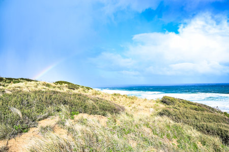 Rainbow over the dunes on the north coast of AUSTRALIAの写真素材
