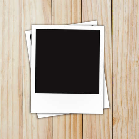 blank  photo frame on brown wood plank backgroundの写真素材