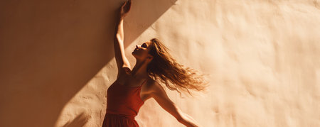 Joyful Woman Dances, Her Hands And Shadows Grace The Wall.の素材
