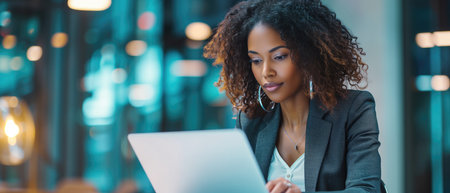 Efficient And Modern: A Professional Woman Embracing Productivity With Her Laptop. Concept Remote Work Essentials, Productivity Hacks, Efficient Workspace, Life As A Digital Nomad.の素材