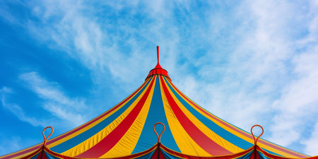 Colorful Striped Circus Tent Set Against A Blue Sky Background. Ð¡oncept Vintage Inspired Garten Party, Romantic Sunrise Beach Shoot, Adventurous Mountain Hike, Urban Street Style Fashion Shoot.の素材