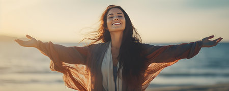 Young woman on beach arms open embracing freedom and relaxation outdoors. Concept Beach photography, Freedom, Relaxation, Outdoor photoshoot, Lifestyle portraitの素材