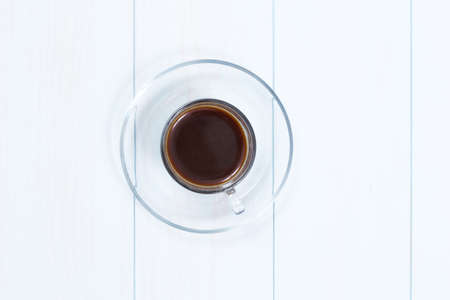 Espresso cup of black coffee on a wood tableの写真素材
