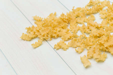 Raw campanelle pasta on blue wood tableの写真素材