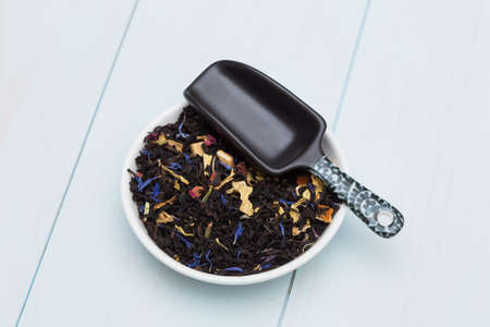 Loose tea leaves on wooden tableの写真素材