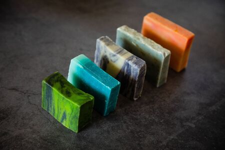 Line of natural hand made soap bars. Dark background. Organic cosmetic.