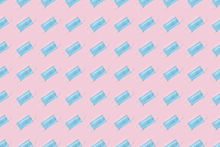 Disposable surgical face mask on pink background.  Healthcare and medical concept. Seamless medical patternの写真素材