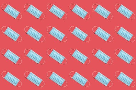 Disposable surgical face mask on red background.  Healthcare and medical concept. Seamless medical patternの写真素材