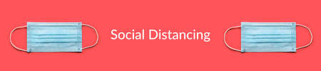 Disposable surgical face mask on red background. Protection against virus. Healthcare and medical concept.  Social Distancing textの写真素材