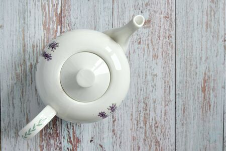 Top view of classic ceramic teapot on wooden tableの写真素材