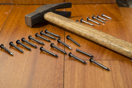 hammer and nails on wooden backgroundの写真素材
