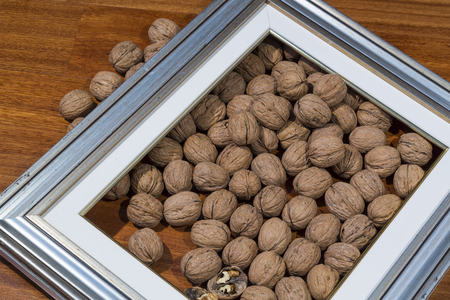 walnuts framed on wooden backgroundの写真素材