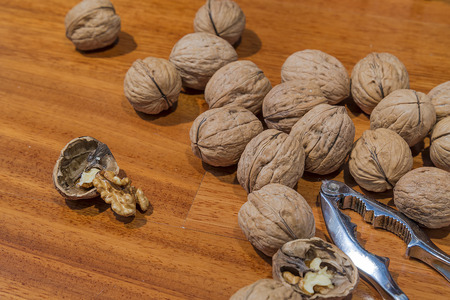 shelled walnut other nuts and nutcrackers on wooden backgroundの写真素材