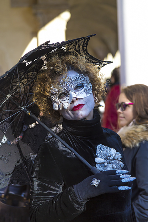 VENICE, ITALY February 25, 2017  beautiful woman in mask with umbrella, Carnival of Veniceのeditorial素材