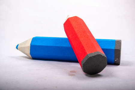 Blue and red pencil stands on a white backgroundの写真素材