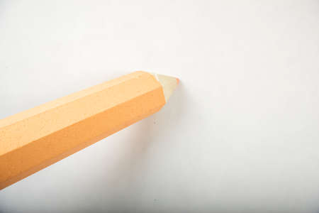Orange pen stands on a white background.の写真素材