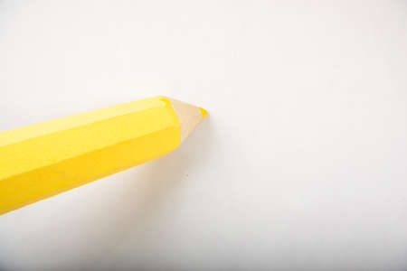 Yellow pencil stands on a white background.