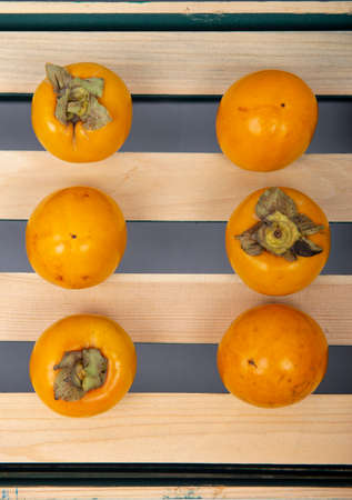 Fresh dates stand in front of a white background on a wooden case.の写真素材