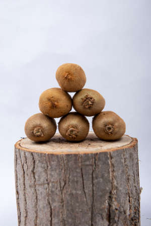 There are kiwi stacked on top of tree stumpsの写真素材