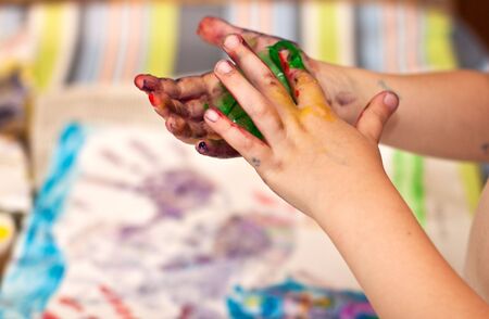 Little Children Hands doing Fingerpainting with various colorsの写真素材