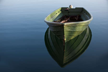 Single Row boat on Lake with Reflection in the Waterの写真素材